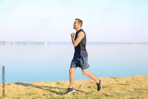 Handsome young man running outdoors