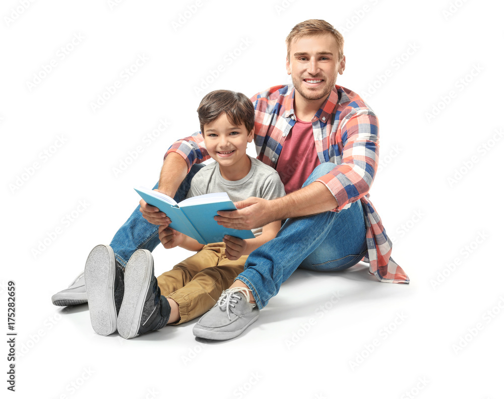 Young man and his little son reading book on white background Young man and his little son reading book on white background