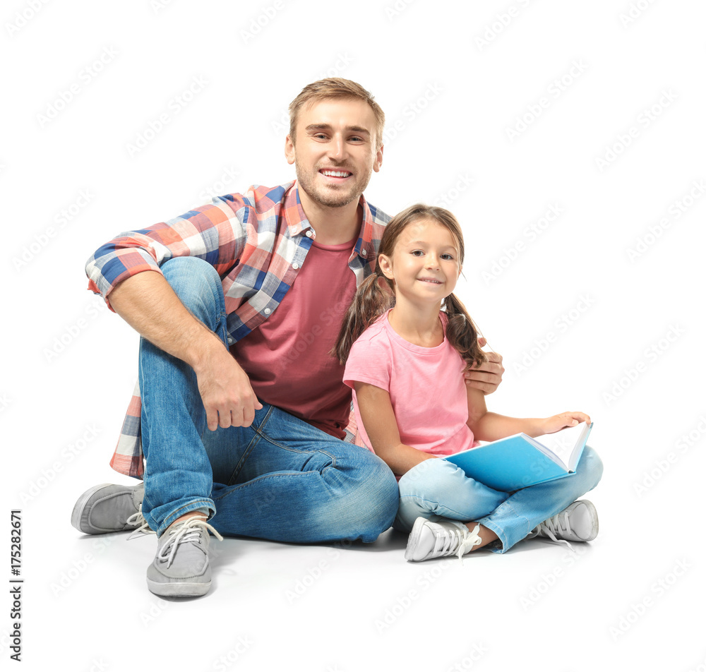 Young man and his little daughter reading book on white background Young man and his little daughter reading book on white background