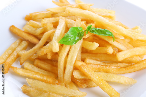 Plate with yummy french fries, closeup