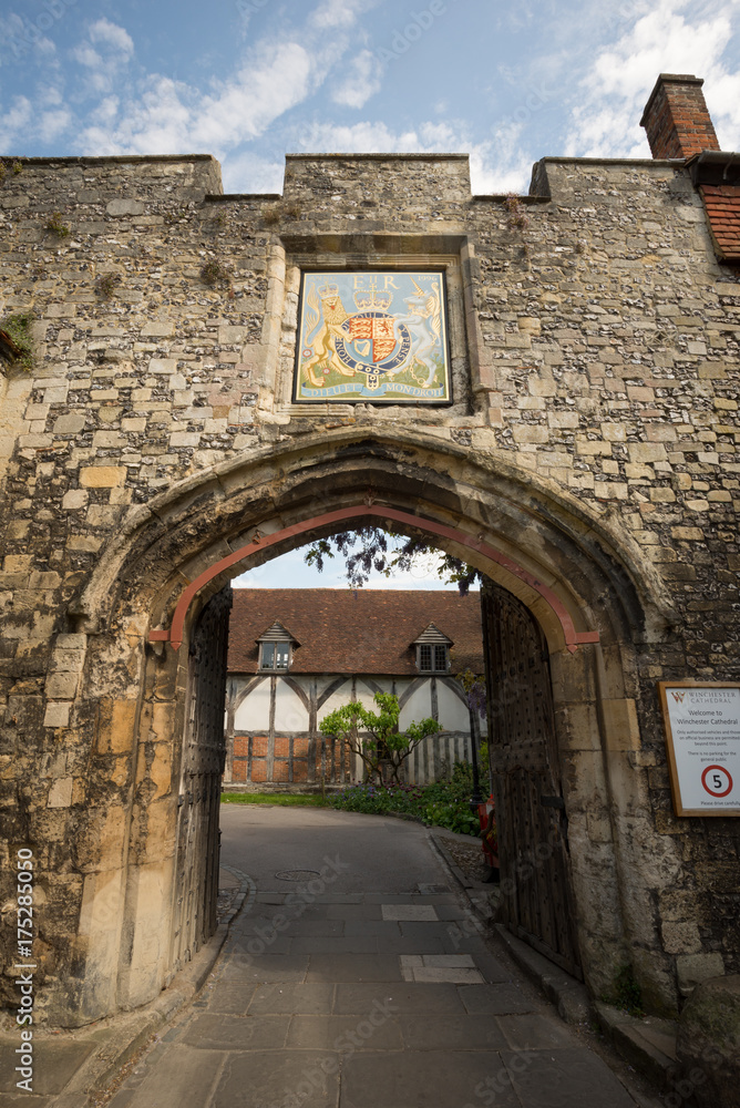 Gated stone archway to Winchester cathedral in Dome alley