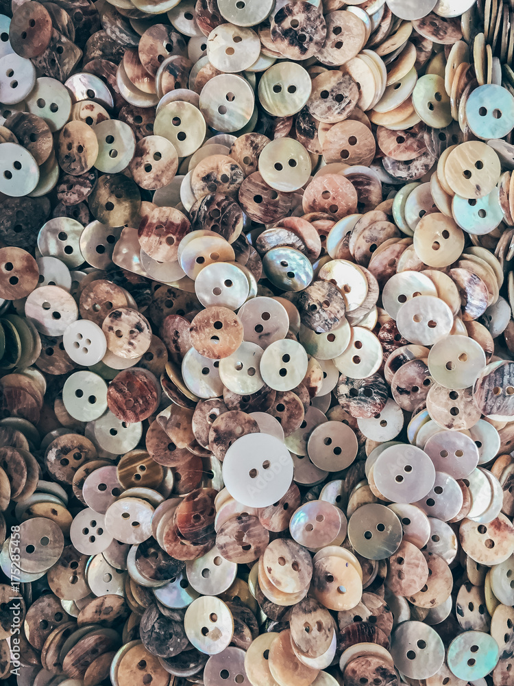 Background or texture of a pile of nacre buttons Background or texture of a pile of nacre buttons