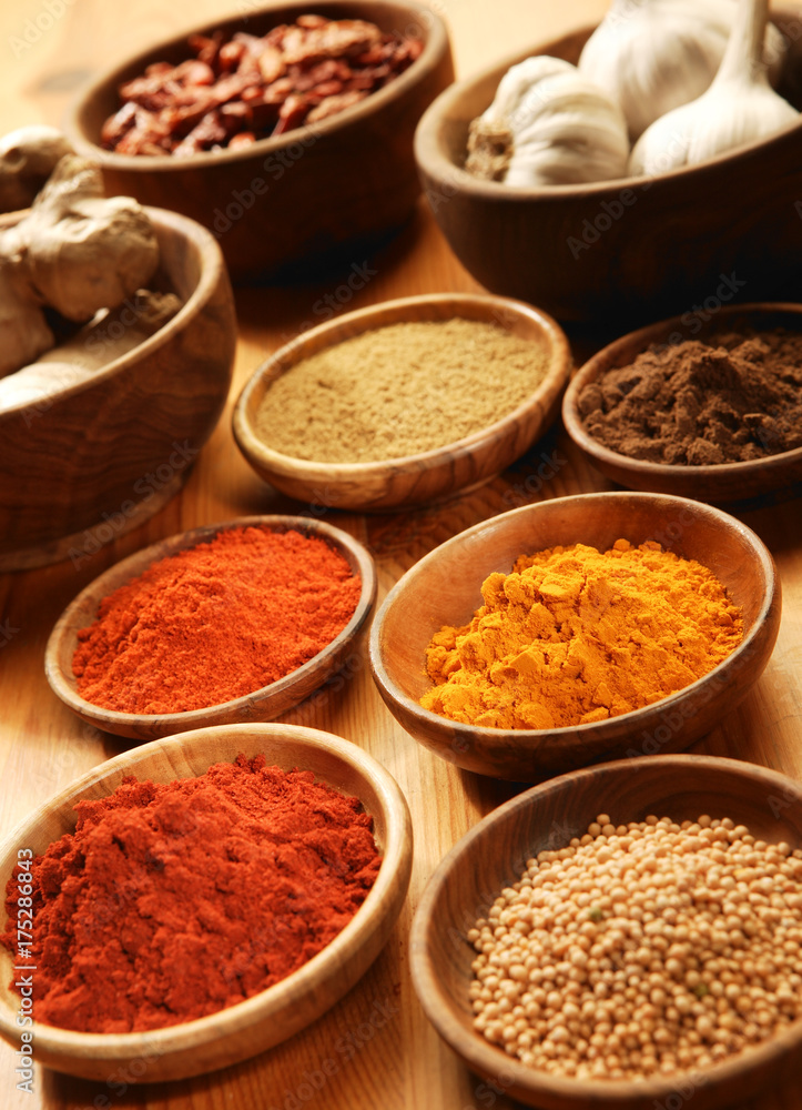Selection of spices in wooden bowls