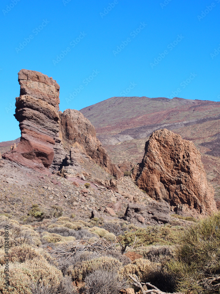 Fototapeta premium towering volcanic rock formations and landscape with mountains in teide national park tenerife