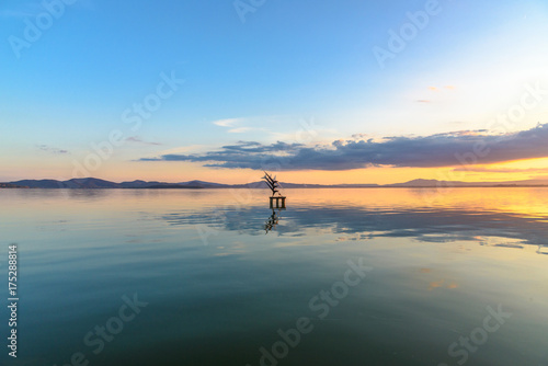 Sculpture on a lake at sunset.