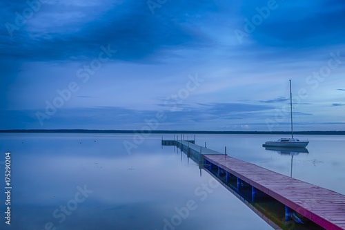 Travel Concepts. Amazing Picturesque Braslav Lakes in Belarus. With Small sailing Boat on The Background. Taken During Blue Hour.