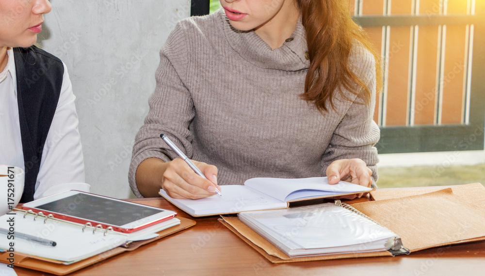Two women are studying and teaching Two women are studying and teaching