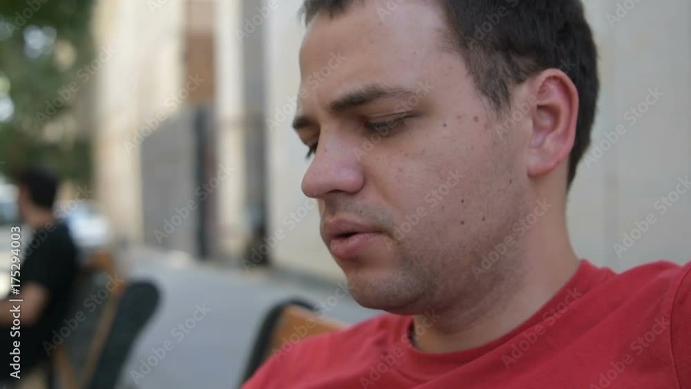 Close up on an unhappy pensive man exhaling vapor from an electronic cigarette Close up on an unhappy pensive man exhaling vapor from an electronic cigarette