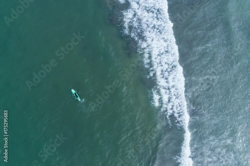 Surfboard on the sea shot from the sky
