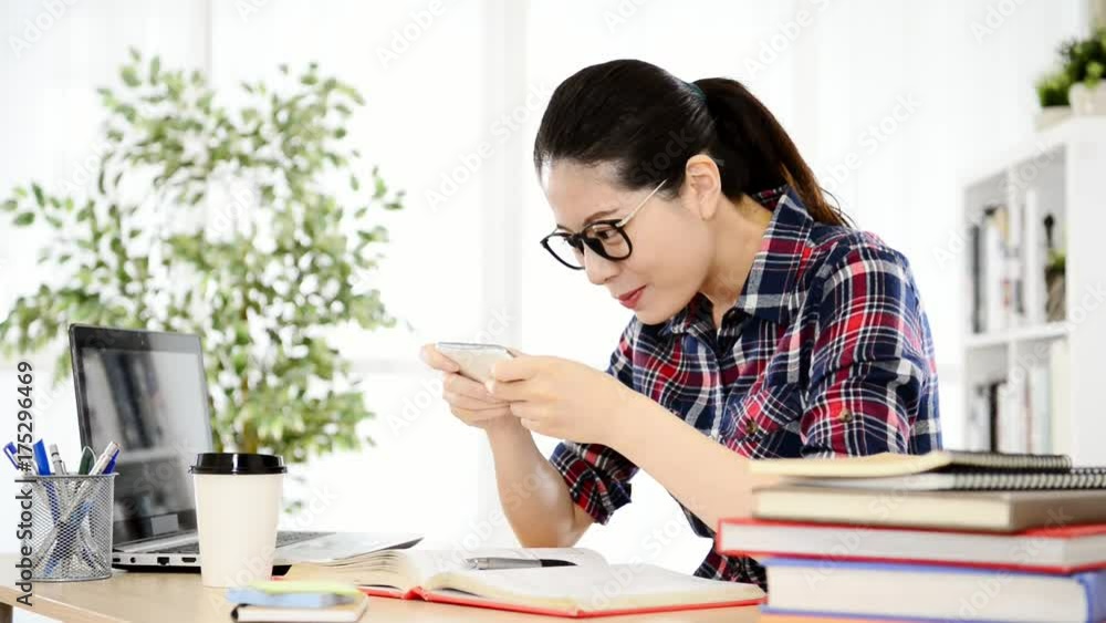 asian student playing smartphone app video game asian student playing smartphone app video game