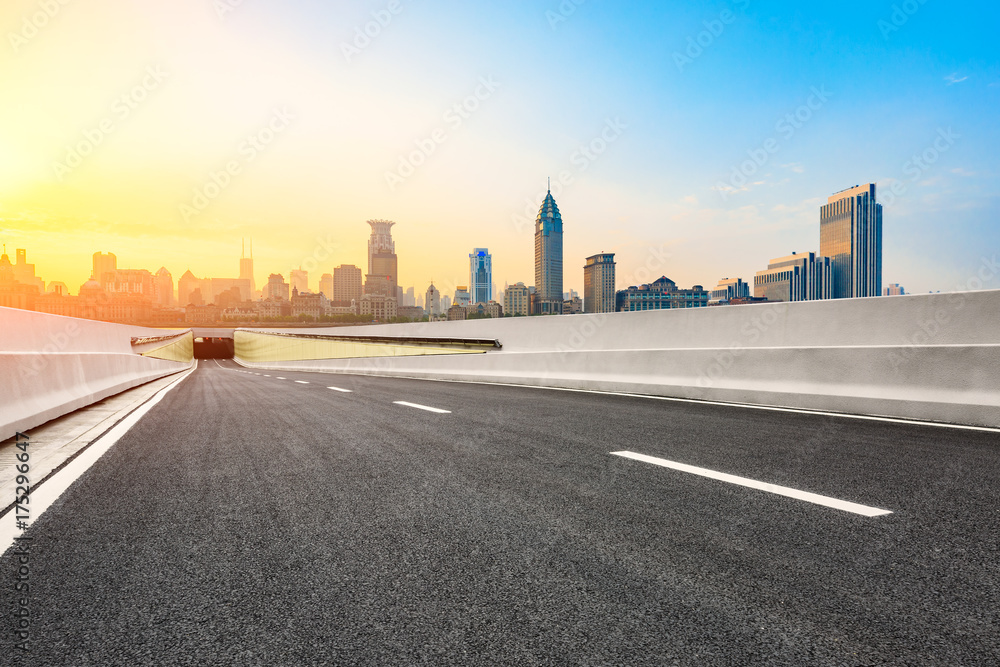 Asphalt road and modern cityscape in Shanghai at sunset Asphalt road and modern cityscape in Shanghai at sunset