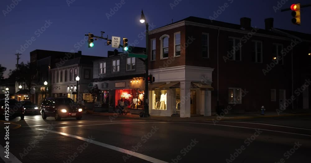 A nighttime establishing shot of businesses on a typical Main Street in America. Pittsburgh suburb. Building names and addresses obscured. A nighttime establishing shot of businesses on a typical Main Street in America. Pittsburgh suburb. Building names and addresses obscured.