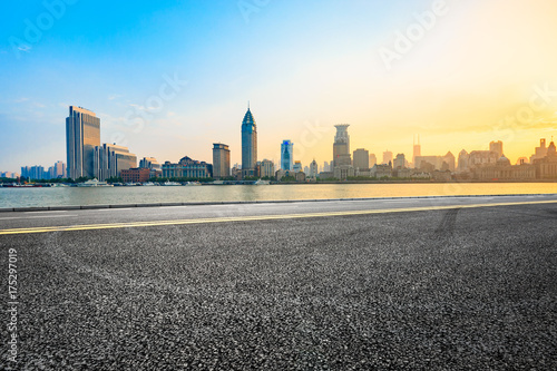 Asphalt road and modern cityscape in Shanghai at sunset