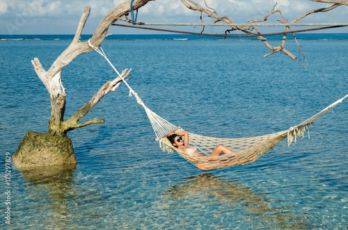 Woman relaxing in the swing in the paradise turquoise sea, Gili Trawangan island, Indonesia © Akarat Phasura