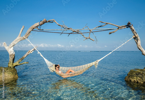 Woman relaxing in the swing in the paradise turquoise sea, Gili Trawangan island, Indonesia © Akarat Phasura