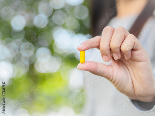 Close up of woman hand holding pills. Health care and medical concept. © Siam
