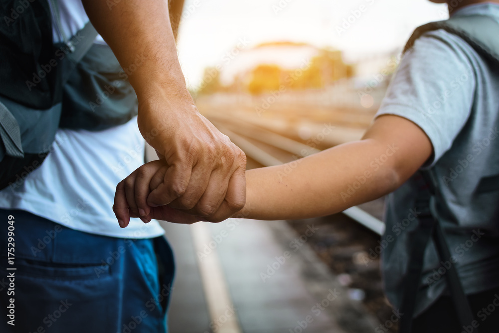 Fototapeta premium Ojciec i syn plecak i trzymając się za ręce na stacji kolejowej w Tajlandii