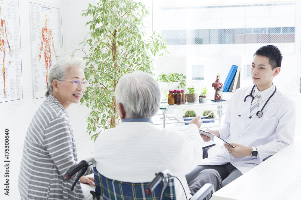 Fototapeta premium A young doctor and an elderly patient have a happy conversation