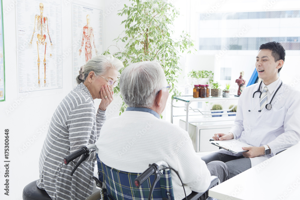 A young doctor and an elderly patient have a happy conversation A young doctor and an elderly patient have a happy conversation