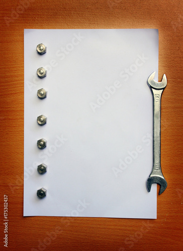 Screws and wrench on the blank paper1 photo