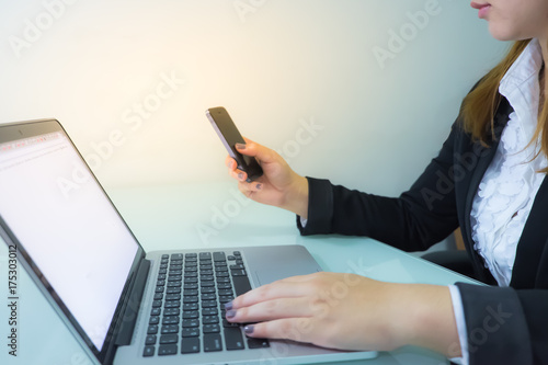 Business woman working on table with notebook and mobile
