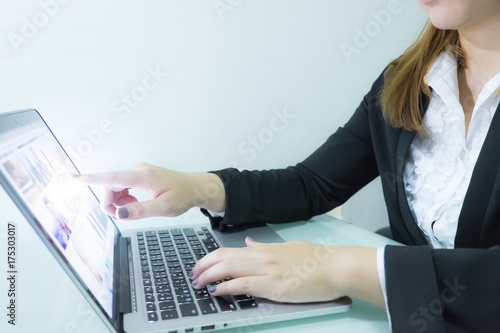 Businesswoman with light pointing in tablet