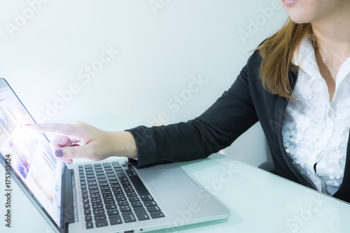 Businesswoman with light pointing in tablet