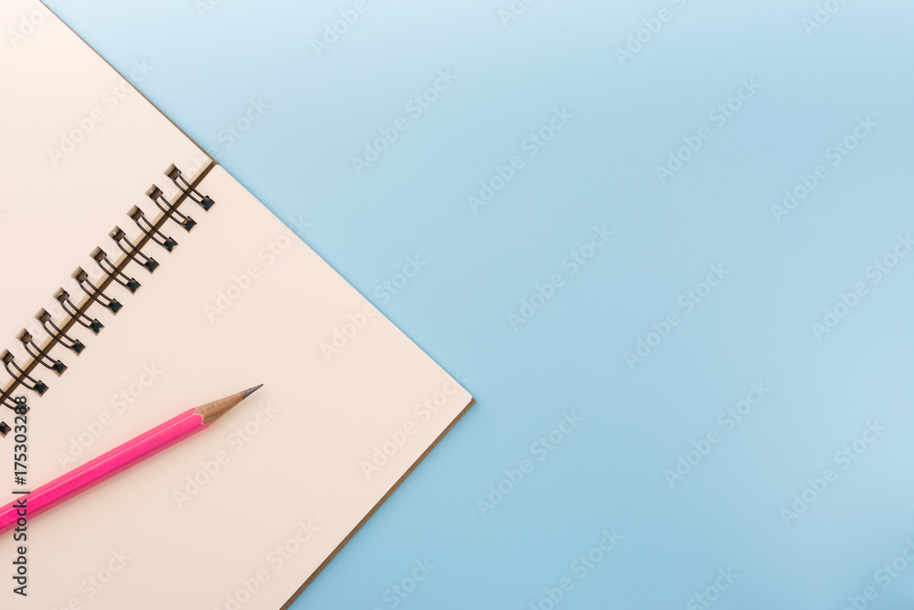 top view of blank notebook and pencil on light blue background with copy space. memo and planning concept. top view of blank notebook and pencil on light blue background with copy space. memo and planning concept.