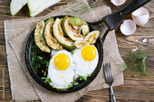 Home-made Breakfast - scrambled eggs, zucchini slices and black coffee.