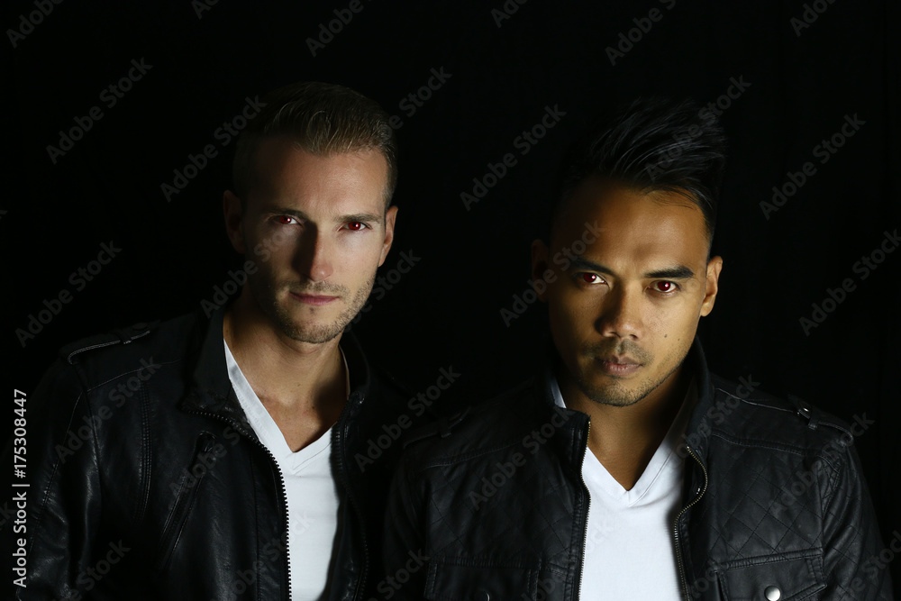 Two handsome vampires posing on a black background Two handsome vampires posing on a black background
