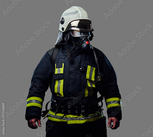 Firefighter dressed in uniform and an oxygen mask.
