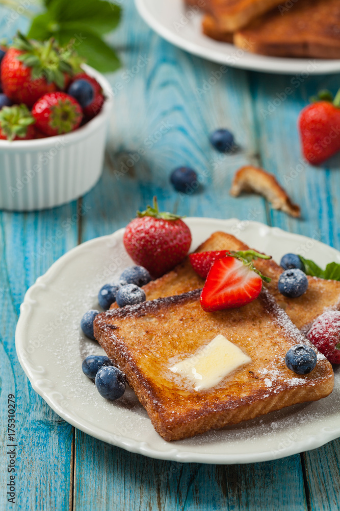 Traditional, delicious, sweet French toast with fruit and butter. Traditional, delicious, sweet French toast with fruit and butter.