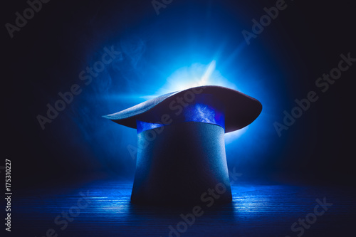 Magician hat on stage floor with dramatic lighting photo