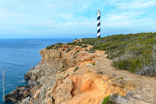 Moscarter lighthouse at the north coast of Ibiza island, Spain photo