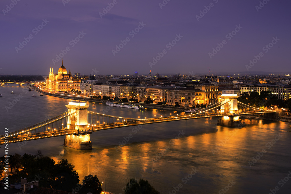 Fototapeta premium Budapest, Hungary. Aerial view of Budapest, Hungary at sunset. View of Buda castle, Chain bridge and Parliament building at night