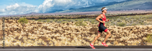 Running triathlon man athlete runner panoramic banner. Triathlete working out in tri suit. Sport athlete on marathon run training exercising cardio in professional outfit for triathlon.