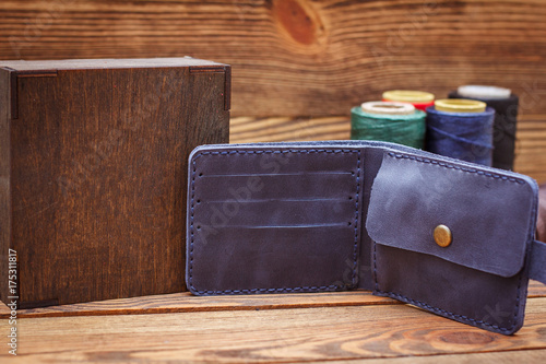Hand made leather man wallet on wooden background