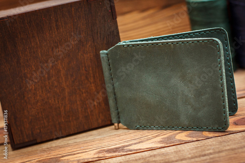 Hand made leather man wallet on wooden background