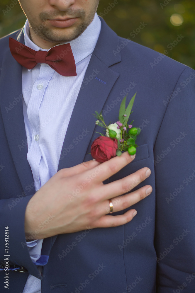 Handsome in blue suit and burgundy bow tie red in buttonhole Stock Photo | Adobe Stock