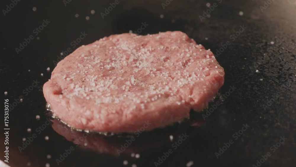 Close up shot of raw beef cutlet for burger frying on electric commercial grill. Close up shot of raw beef cutlet for burger frying on electric commercial grill.