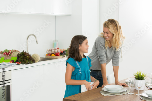 baby sitter and young girl in the kitchen