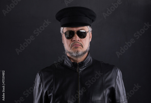 studio portrait of a man in a black winter hat © serikbaib
