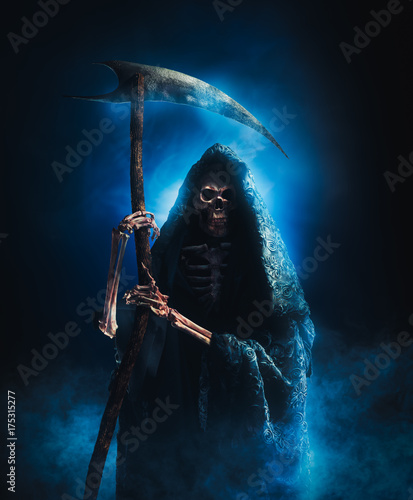 grim reaper with scythe on a smoky background / high contrast image