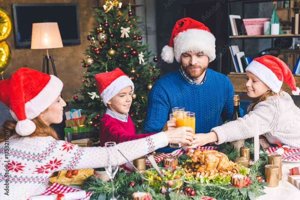 family clinking glasses on christmas dinner family clinking glasses on christmas dinner