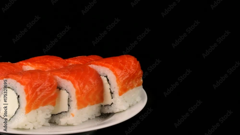 Philadelphia rolls are rotating on a plate, Japanese cuisine Philadelphia rolls are rotating on a plate, Japanese cuisine