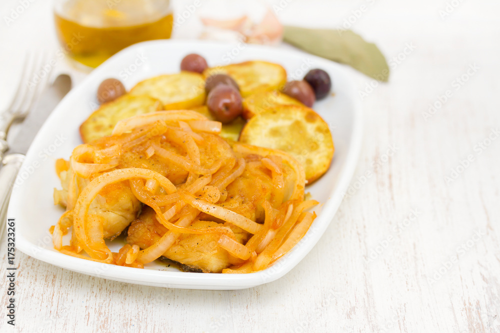 fried cod fish with onion and olive oil on dish fried cod fish with onion and olive oil on dish