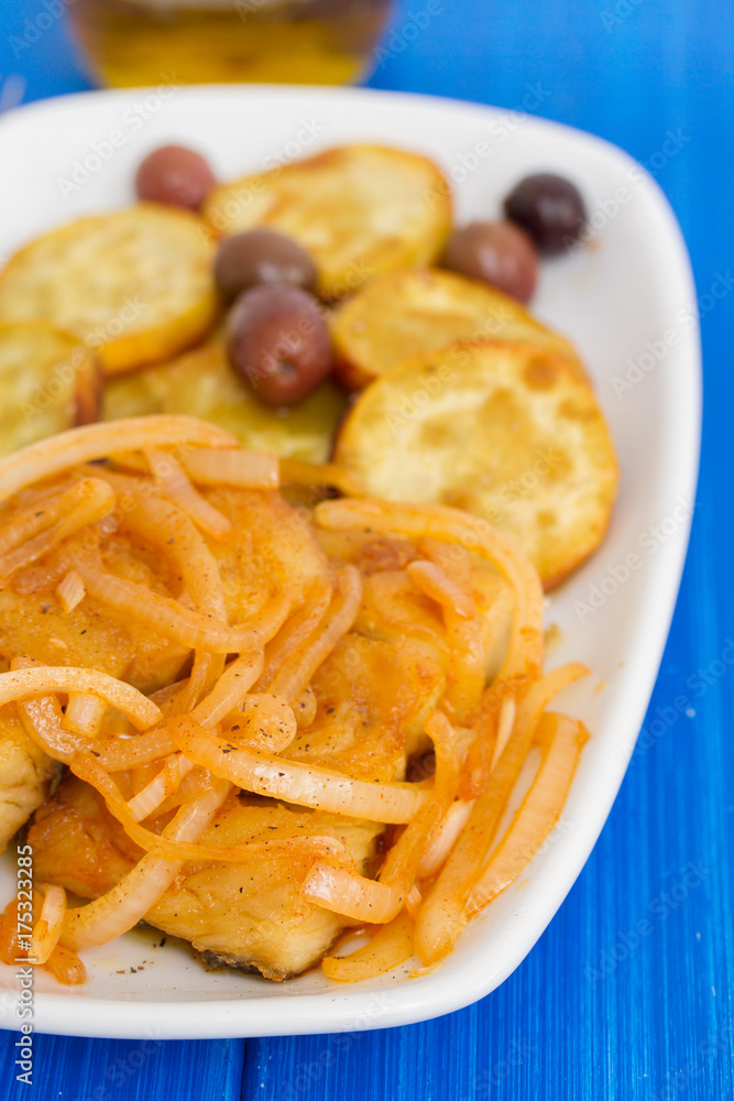 fried cod fish with onion and olive oil on dish fried cod fish with onion and olive oil on dish