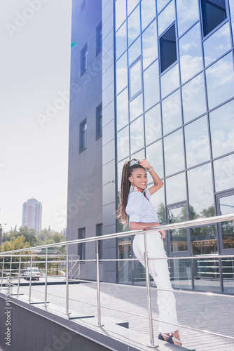 Woman leaning on guardrails