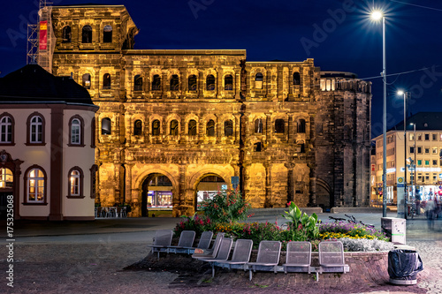 The Porta Nigra, Latin - black gate, view from south, Trier, Germany. Ancient architectural structure in night illumination. Famous landmark of Trier and North Rhine-Westphalia.