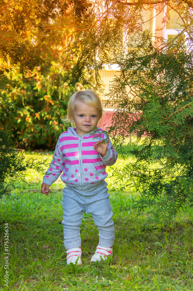 adorable happy baby girl with blond hair walking in the park adorable happy baby girl with blond hair walking in the park